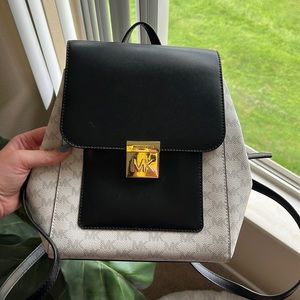 Michael Kors backpack purse. Width is 8.5 inches and the bag is 9 inches deep.